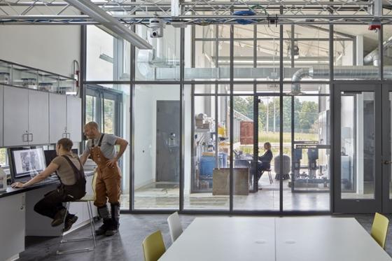 Photo of Chatham University students and instructors gathering in the industrial style field lab at Eden Hall Farm.